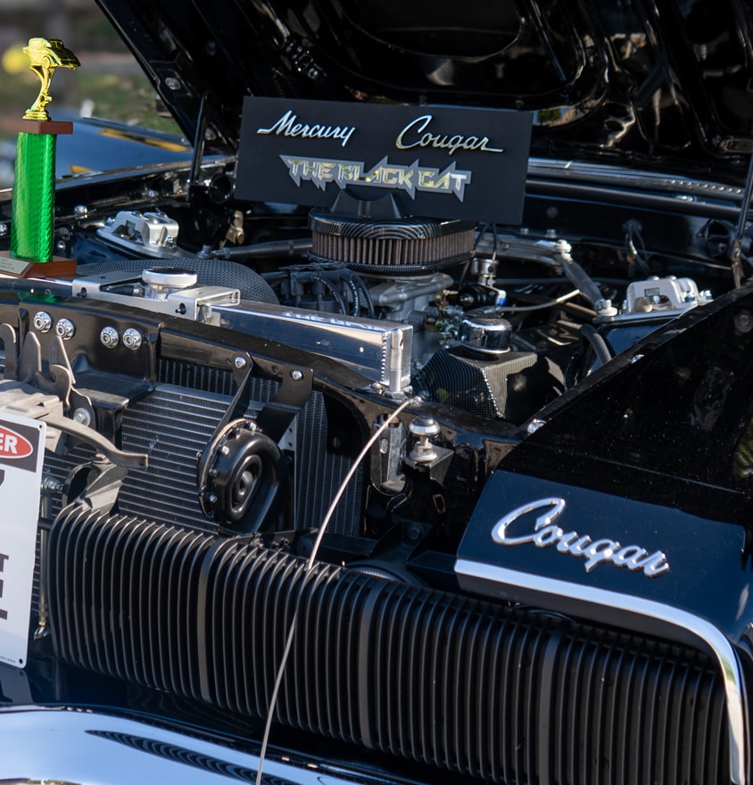 Mercury Cougar Black Cat engine bay with trophy at car show