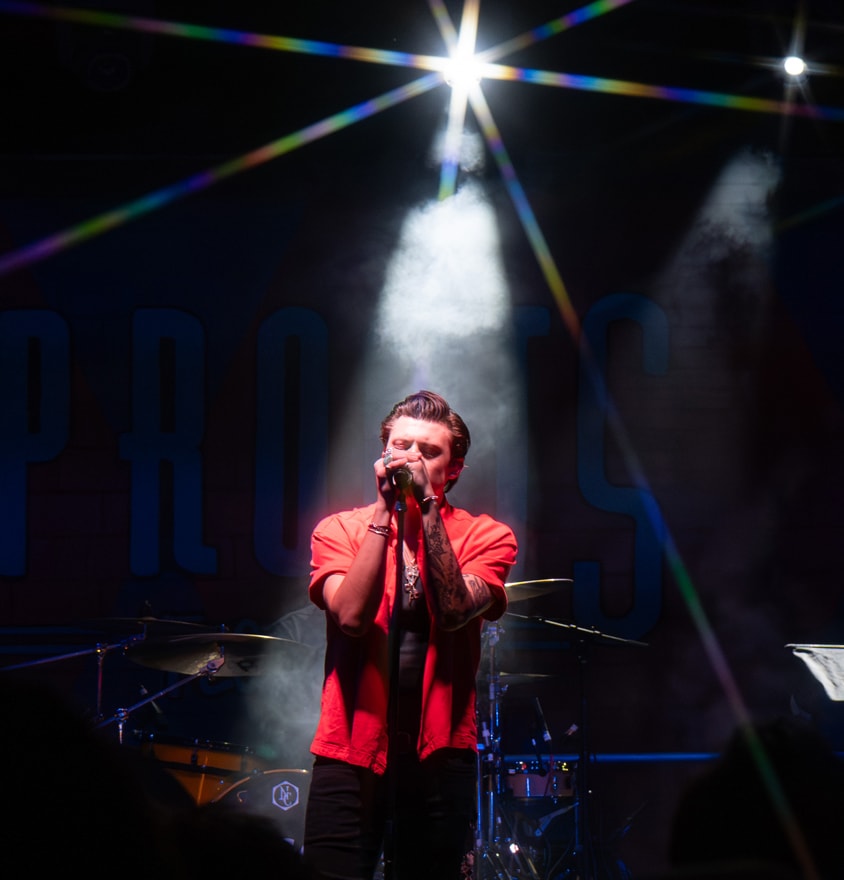 Singer performing on stage with spotlight