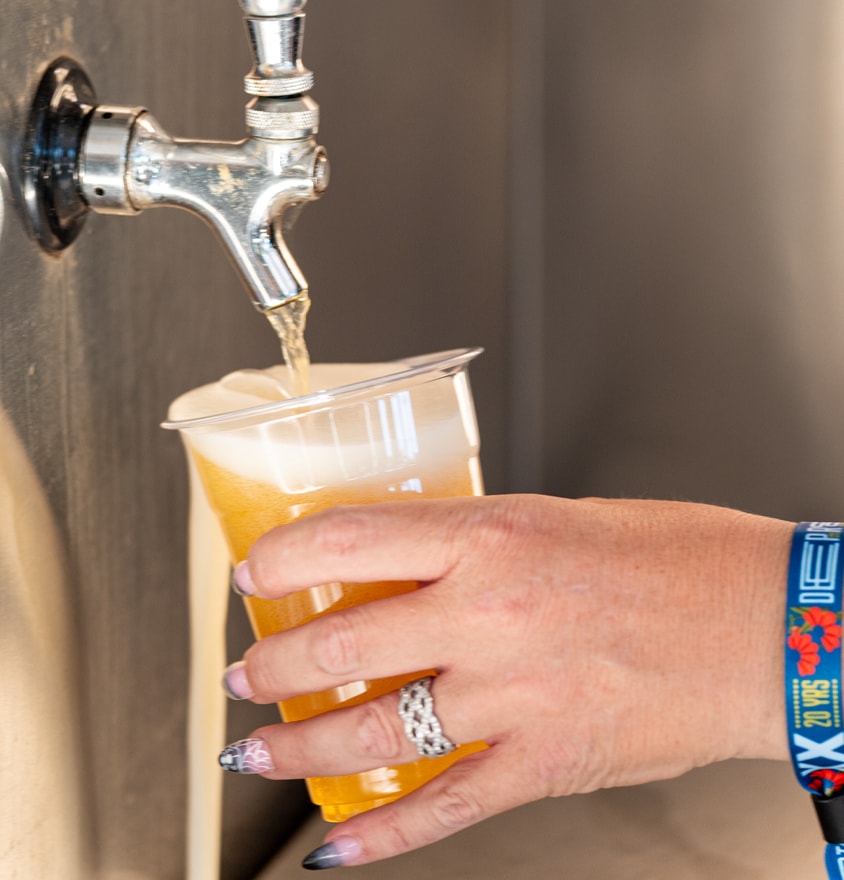 Hand pouring beer from tap