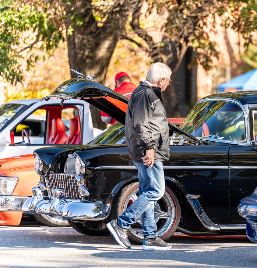 Man admiring classic cars at Deep Roots Car Show