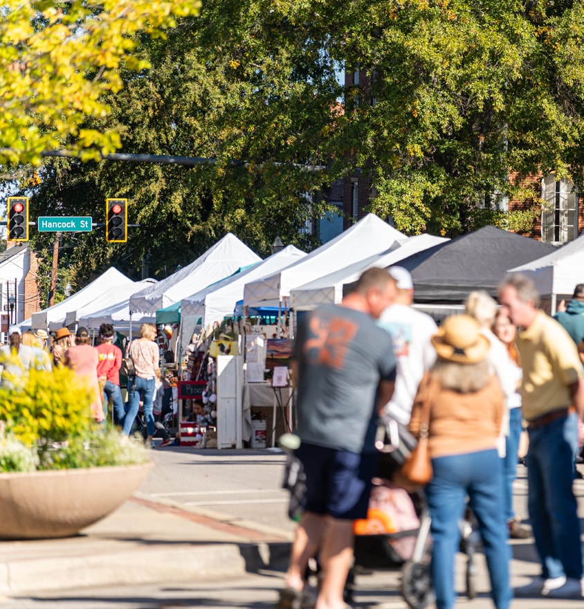 Outdoor street festival with white tents